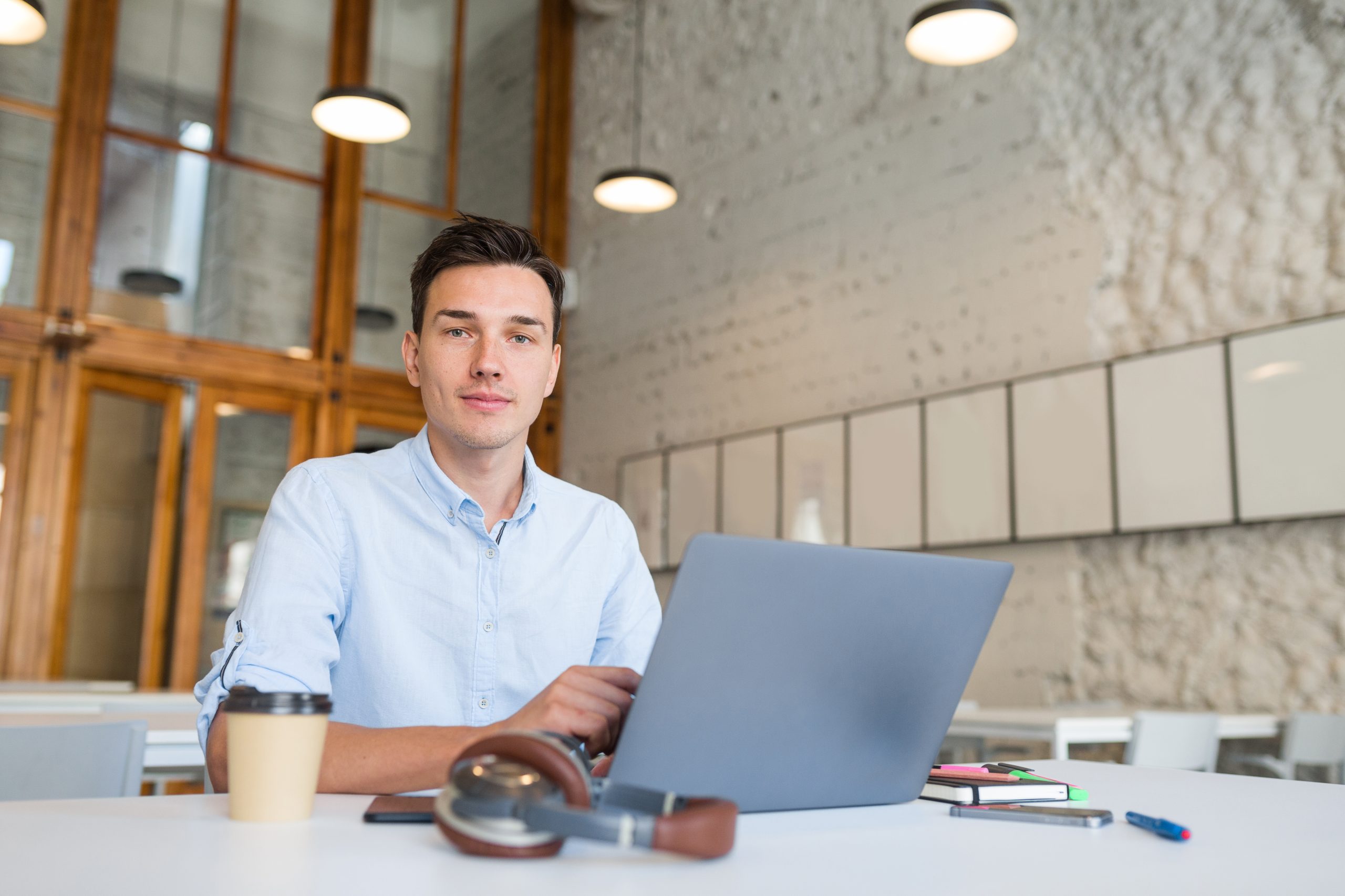 A young Australian man  working on a laptop to transfer the domain.